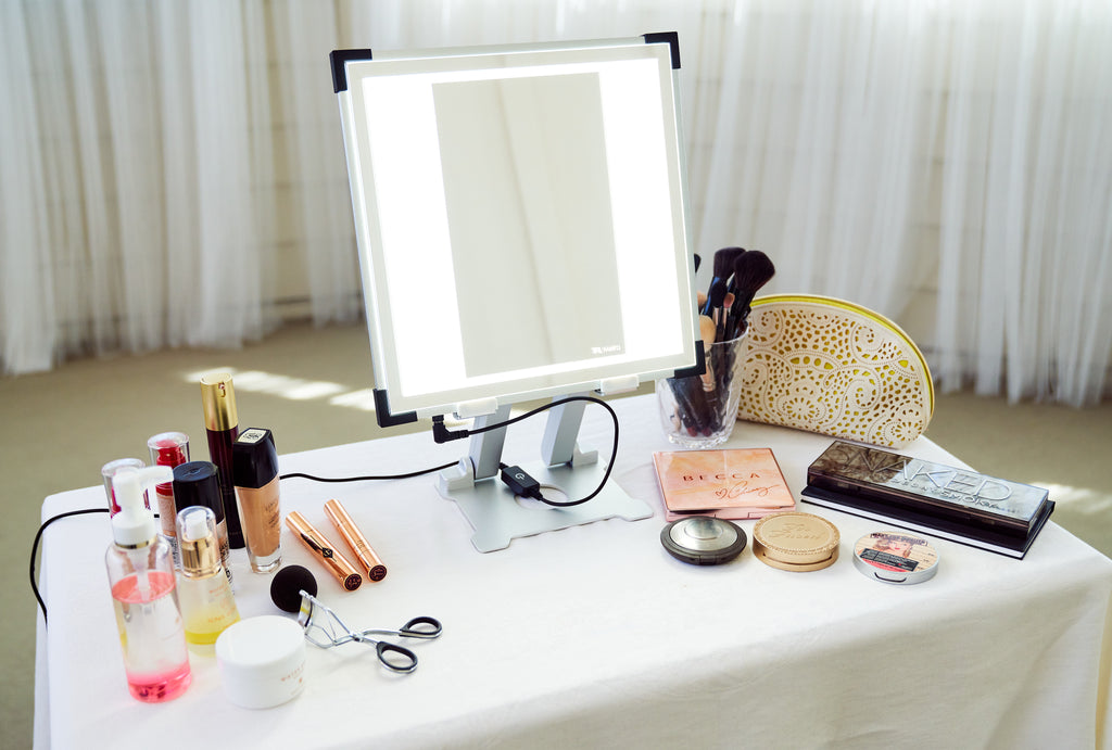 TML Meira Makeup Vanity sitting atop a table with beauty tools surrounding it