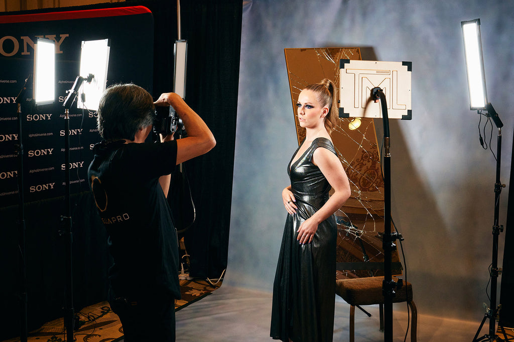 A photographer photographing a model using only The Makeup Light light panels